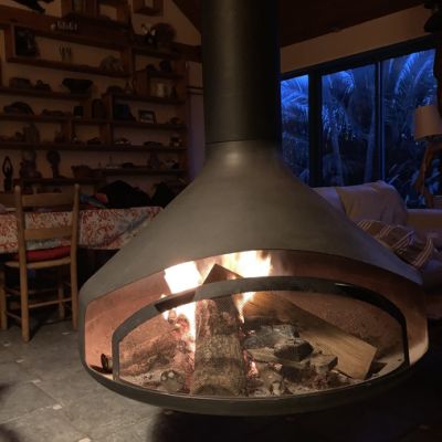 Suspended wood-burning fireplace in use